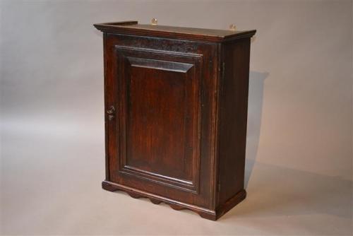 An early 18th century oak table spice cupboard