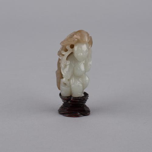 A Chinese pale celadon and russet jade carving, 18th Century