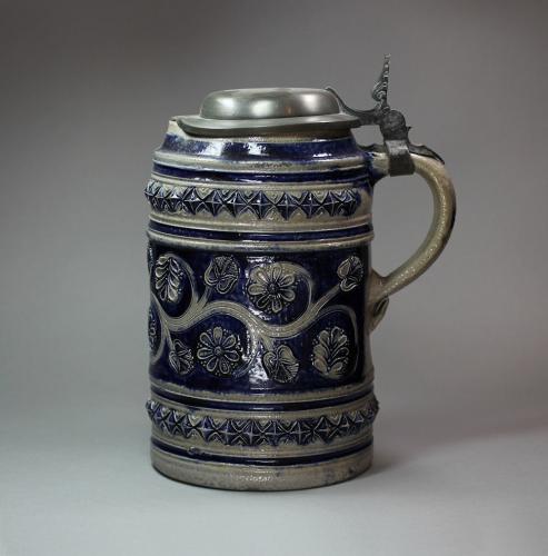 German stoneware tankard with pouring lip and flat pewter cover