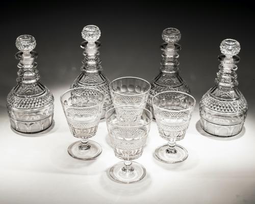 A Fine Set of Four Elaborate Cut Glass Regency Decanters with Matching Goblets