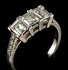 Platinum set emerald cut diamond three stone ring