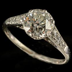 Platinum set single stone ring with diamond shoulders