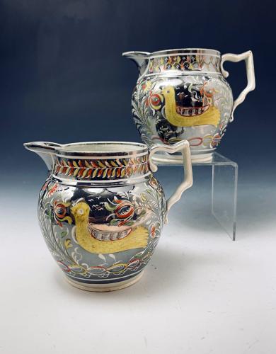 Silver lustre pottery pitchers resist decorated with enamel colors c1815