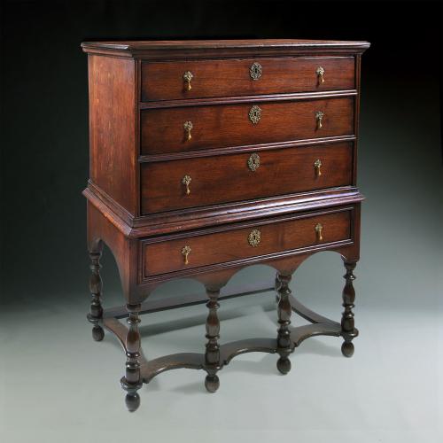 An early 18th century oak chest on stand