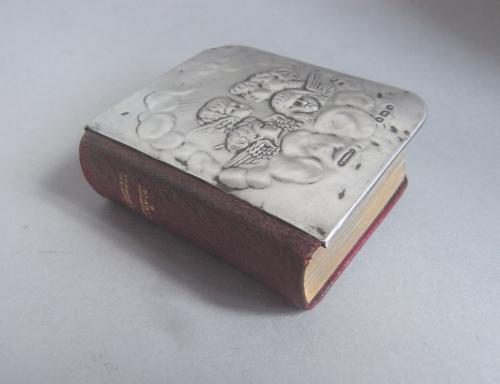 A rare silver mounted miniature book of the Common Prayer.  The silver cover made in Birmingham in 1902