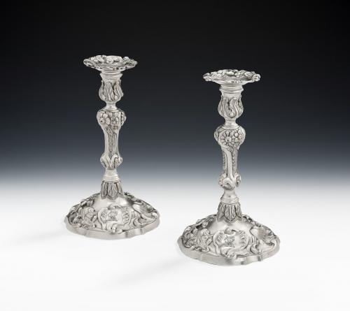 An extremely rare pair of George II cast Rococo Tapersticks made in London in 1757 & 1759 by Samuel Courtauld I