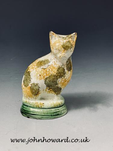 Early Staffordshire pottery figure of a seated cat decorated with underglaze oxide colours circa 1795