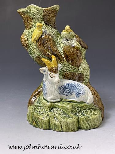Prattware pottery tree trunk figure with a blue goat and yellow birds circa 1800