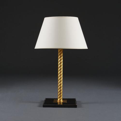 A Twisted Brass and Black Leather Lamp after Jacques Adnet