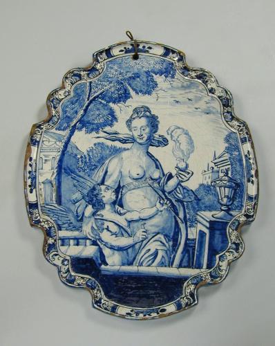 Dutch delft oval plaque painted in blue with Venus and Cupid, c.1760