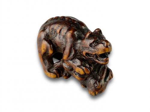 Boxwood netsuke of a snarling wolf attacking a hare. Japanese, 18th century
