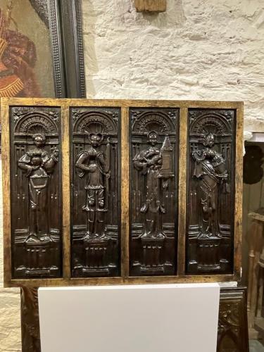  A BEAUTIFUL FRAMED SET OF FOUR EARLY 16TH CENTURY CARVED OAK PANELS. CIRCA 1530.