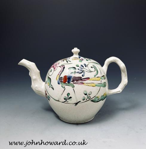 Staffordshire stoneware salt-glaze teapot with enamel decoration of a bird and flowers circa 1760