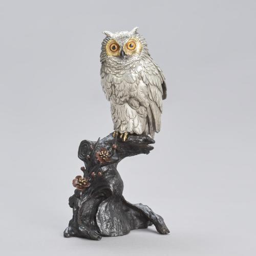 Japanese bronze owl with silvered body perched on a plum blossom tree with inlaid glass eyes, signed Mitani sei  Meiji Period.