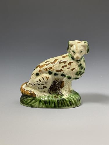 Staffordshire pottery creamware bodied figure of a seated dog Whieldon type circa 1770