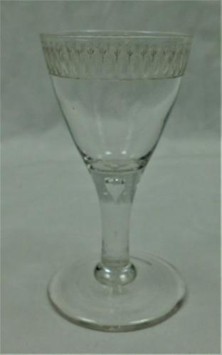 A plain stem wine glass engraved with an egg & dart border, English circa 1780