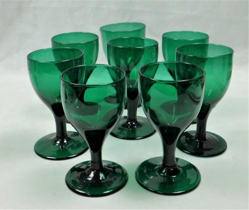 A set of eight tulip shaped 'Bristol' green wine glasses, English circa 1800.