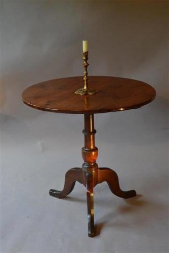 A George III yew wood tilt top pedestal table