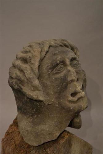 A medieval stone grotesque head of a man
