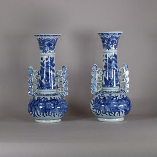 front of pair of vases