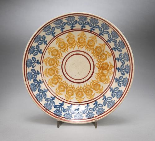 Dished Spongeware Plate With Blue and Yellow Floral Decoration and Red Lines to the Border and Centre  Glazed Polychrome Decorated Pottery  British, c.1870