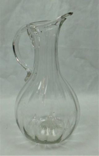 A free blown rib moulded glass jug, France circa 1830