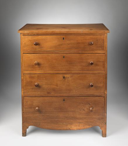 Refined Georgian Vernacular Chest of Four Long Drawers With Shaped Apron and Original Turned Wood Handles  Solid Elm with Boxwood Stringing to the Top and Drawer Fronts  English, c.1800