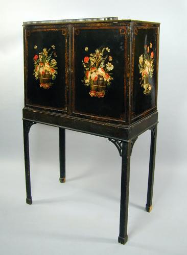 An unusual George III cabinet on original stand with finely painted tole panels, probably Wolverhampton, c.1770