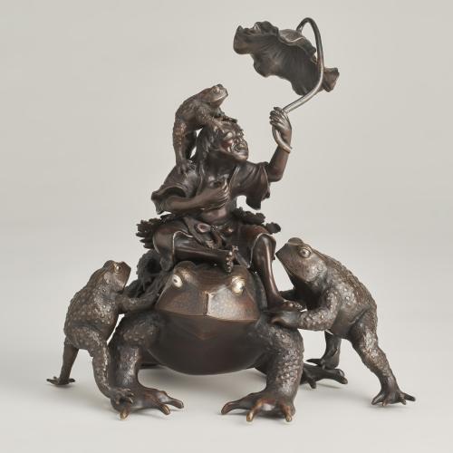 An amusing Bronze Okimono of Gama Sennin with a group of large toads