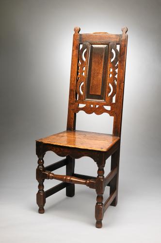 Remarkable Pair of William and Mary Period Side Chairs With Decorative Open Work Detailing Framing the Panel Backs Solid Well Burnished Nutty Coloured Oak English, c.1700