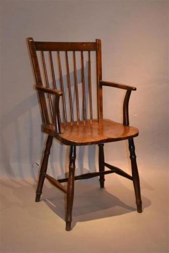 An early 19th century burr elm seat armchair