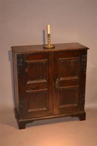 A very small Queen Anne oak cupboard