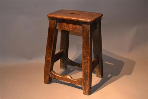 An early 19th century elm and pine stool
