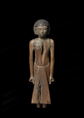 An Egyptian wood figure of a man