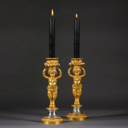 A Pair of Louis XVI Style Gilt-Bronze and Polished Steel Candlesticks By Maison Beurdeley.