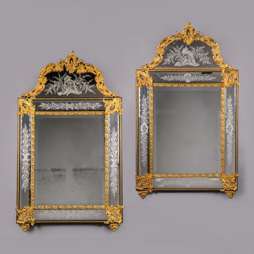 A Pair of Régence Style Gilt-Bronze, Ebonised and Etched Glass Mirrors. France. Circa, 1860.
