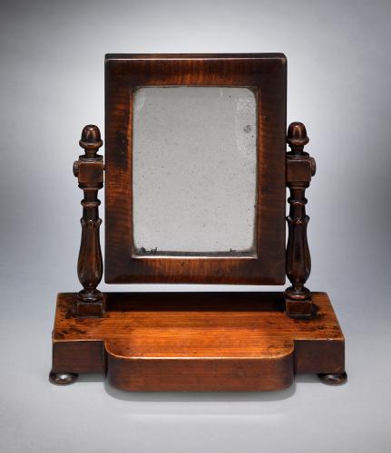 Delightful Apprentice Made Miniature Toilet Mirror The Mirror Pivoted on Two Turned Uprights and Raised on a Platform Base Beautifully Figured and Patinated Mahogany English, c.1875