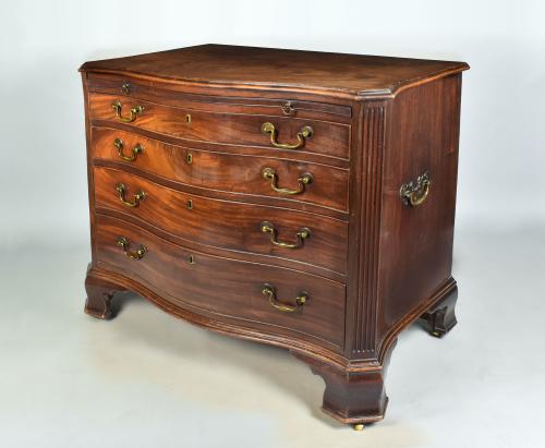 George III mahogany serpentine chest with brushing slide, original handles and carrying handles and double ogee feet, c.1780