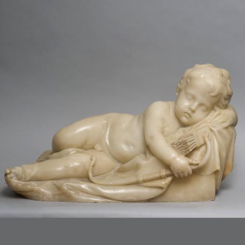 A 19th century Italian alabaster figure of a sleeping cupid