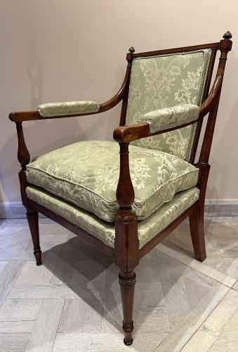 A pair of George III satinwood and ebonised armchairs