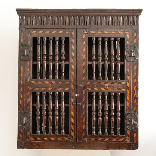 A Charles I joined and boarded oak and inlaid mural livery cupboard, West Country, circa 1640