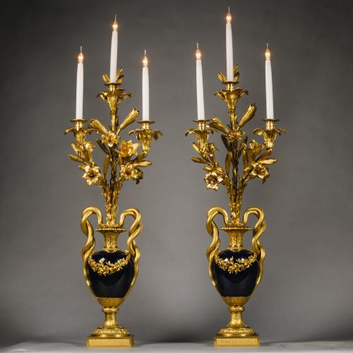 A Pair Of Louis XVI Style Porcelain Three-Light Vase Candelabra