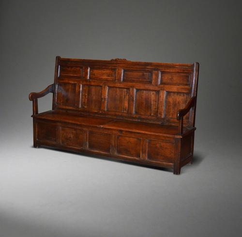A large Queen Anne oak box seated settle.