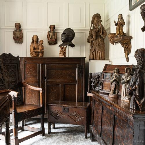 a room full of early oak furniture and sculpture