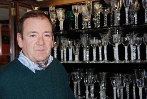 Tim Osborne with a small selection of 18th century wineglasses.