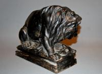 cast iron C19th doorstop depiction a large lion with its prey, a wild boar, at its mercy.