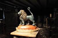 17TH CENTURY CARVED AND POLYCHROMED LIMEWOOD SCULPTURE OF A LION PASSANT.