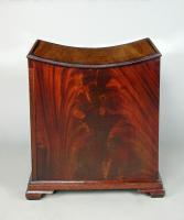 An unusual George III concave topped mahogany stool with side opening door, c.1790