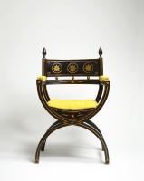 An impressive ebonised and gilt decorated Regency Period x-framed armchair  English, 1810