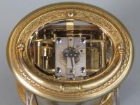 Drocourt An engraved oval carriage clock escapement